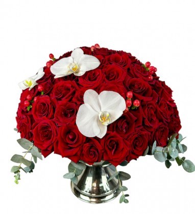 red roses in silver vase